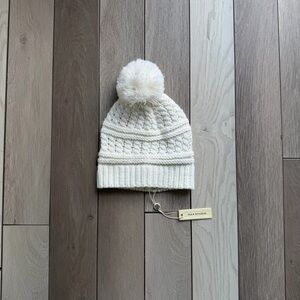 Max Studio ivory cable knit beanie with a pom-pom.
